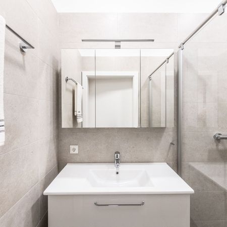 Badezimmer mit Blick auf Spiegel, Waschbecken und Dusche