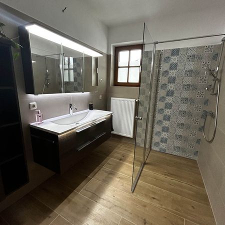 Badezimmer mit moderner Dusche und Waschbeckenanlage